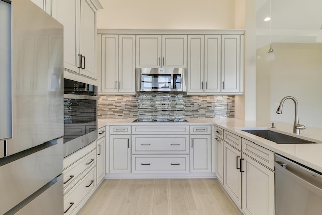 9252 SW Miracoli Way, Port Saint Lucie, FL 34987 - kitchen with backsplash, light countertops, appliances with stainless steel finishes, and a sink