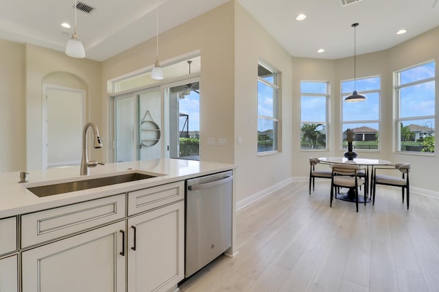 9252 SW Miracoli Way, Port Saint Lucie, FL 34987 - kitchen featuring hanging light fixtures, a sink, stainless steel dishwasher, baseboards, and visible vents