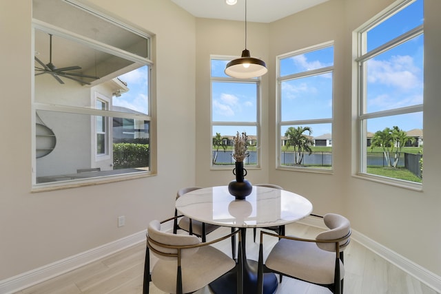 9252 SW Miracoli Way, Port Saint Lucie, FL 34987 - dining area with light wood finished floors, a water view, baseboards, and ceiling fan