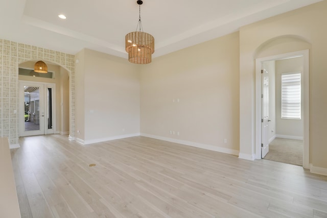 9252 SW Miracoli Way, Port Saint Lucie, FL 34987 - unfurnished room with recessed lighting, baseboards, an inviting chandelier, a raised ceiling, and light wood-style floors