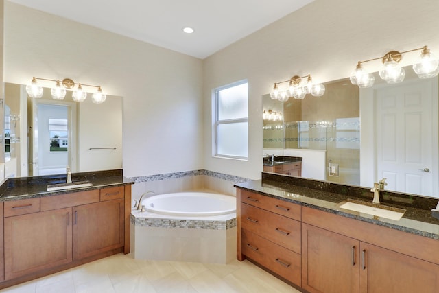 9252 SW Miracoli Way, Port Saint Lucie, FL 34987 - bathroom featuring a tile shower, a bath, two vanities, and a sink