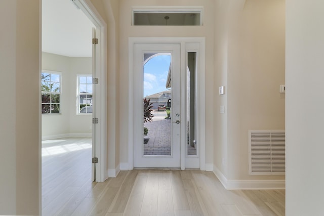 9252 SW Miracoli Way, Port Saint Lucie, FL 34987 - foyer entrance featuring baseboards, visible vents, and wood finished floors