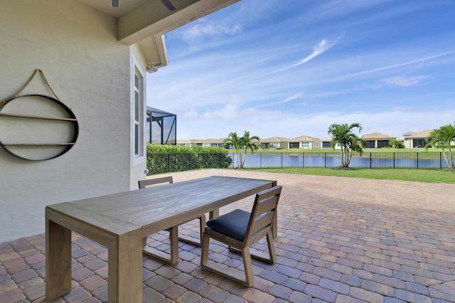 9252 SW Miracoli Way, Port Saint Lucie, FL 34987 - view of patio featuring outdoor dining area, a water view, a residential view, and a fenced backyard