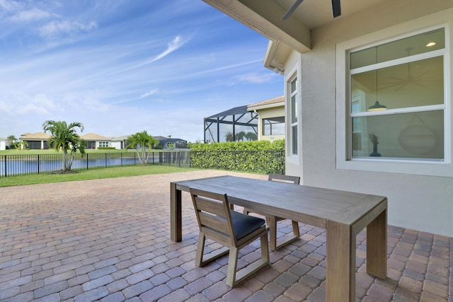 9252 SW Miracoli Way, Port Saint Lucie, FL 34987 - view of patio with a water view, outdoor dining area, a fenced backyard, and a lanai