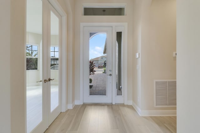 9252 SW Miracoli Way, Port Saint Lucie, FL 34987 - entryway featuring baseboards, visible vents, and wood finished floors