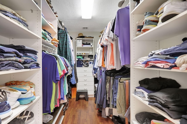 walk in closet featuring visible vents and wood finished floors