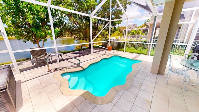 2323 NW Padova St, Port Saint Lucie, FL 34986 - view of swimming pool featuring glass enclosure, a patio, a fenced in pool, and a water view