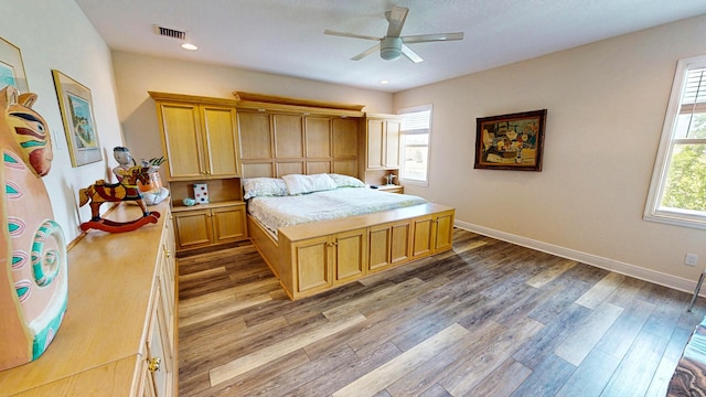 2323 NW Padova St, Port Saint Lucie, FL 34986 - bedroom with a ceiling fan, baseboards, visible vents, and wood finished floors