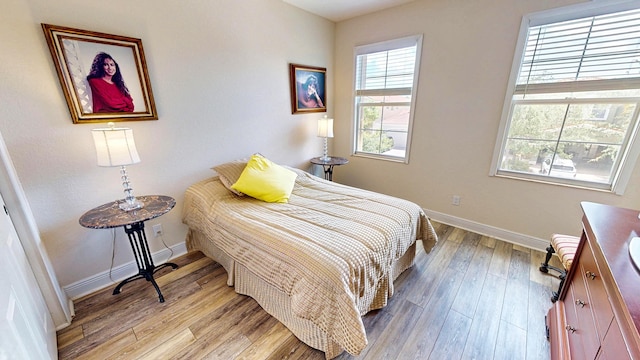 2323 NW Padova St, Port Saint Lucie, FL 34986 - bedroom featuring baseboards and light wood-style flooring