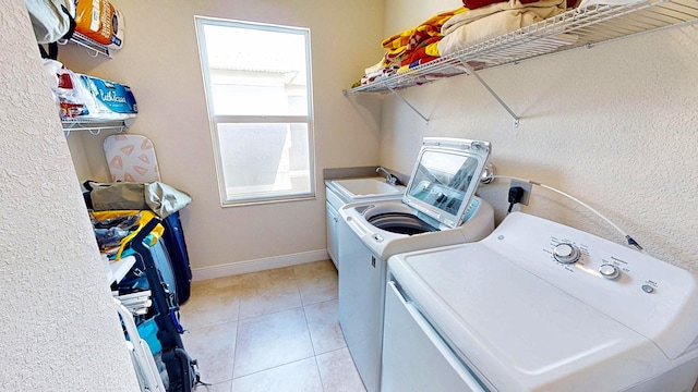 2323 NW Padova St, Port Saint Lucie, FL 34986 - washroom with laundry area, baseboards, independent washer and dryer, and light tile patterned floors