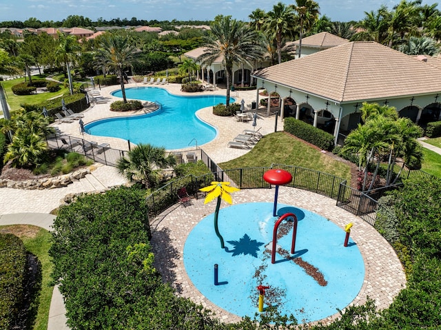 2323 NW Padova St, Port Saint Lucie, FL 34986 - community pool featuring fence, a patio area, and a water play area
