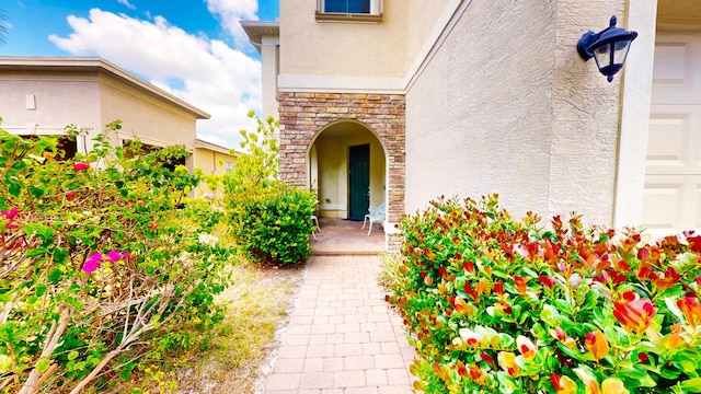 2323 NW Padova St, Port Saint Lucie, FL 34986 - property entrance with stone siding and stucco siding