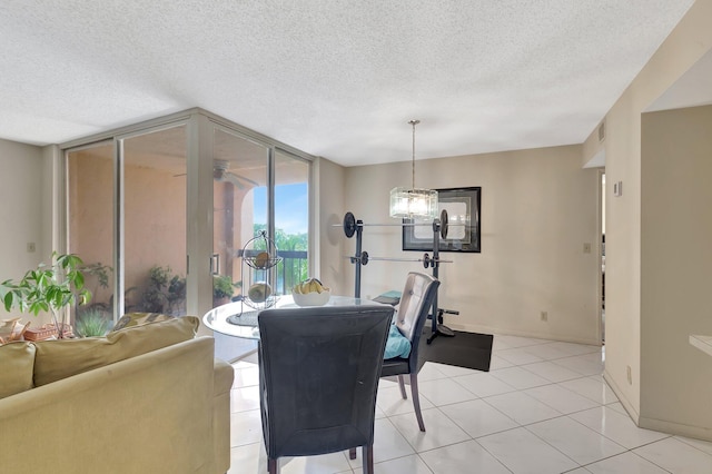 950 Egret Cir Unit 5409, Delray Beach, FL 33444 - dining area featuring light tile patterned floors, a textured ceiling, and baseboards