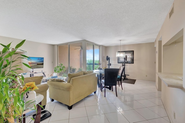 950 Egret Cir Unit 5409, Delray Beach, FL 33444 - living area with a textured ceiling, visible vents, light tile patterned floors, and an inviting chandelier