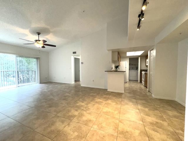 unfurnished living room featuring ceiling fan, track lighting, and light tile patterned floors