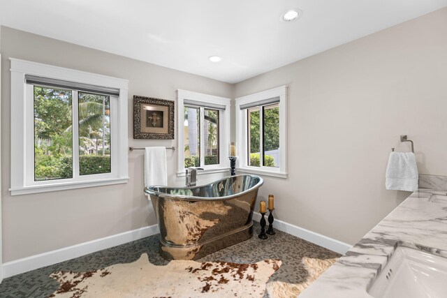 121 Hillcrest Dr, Sewalls Point, FL 34996 - full bathroom with baseboards, plenty of natural light, a soaking tub, and recessed lighting