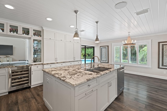 121 Hillcrest Dr, Sewalls Point, FL 34996 - kitchen with wine cooler, stainless steel dishwasher, a sink, dark wood finished floors, and white cabinetry