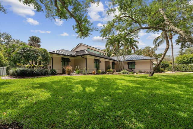 121 Hillcrest Dr, Sewalls Point, FL 34996 - view of front of home featuring a standing seam roof, metal roof, and stucco siding