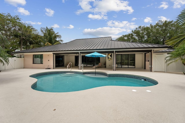 121 Hillcrest Dr, Sewalls Point, FL 34996 - swimming pool featuring a patio area, a gate, and fence