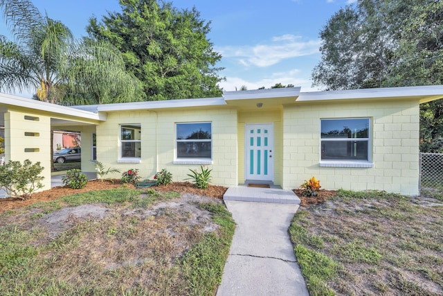 3205 Tennessee Ave, Fort Pierce, FL 34950 - view of front of home featuring concrete block siding, fence, and an attached carport