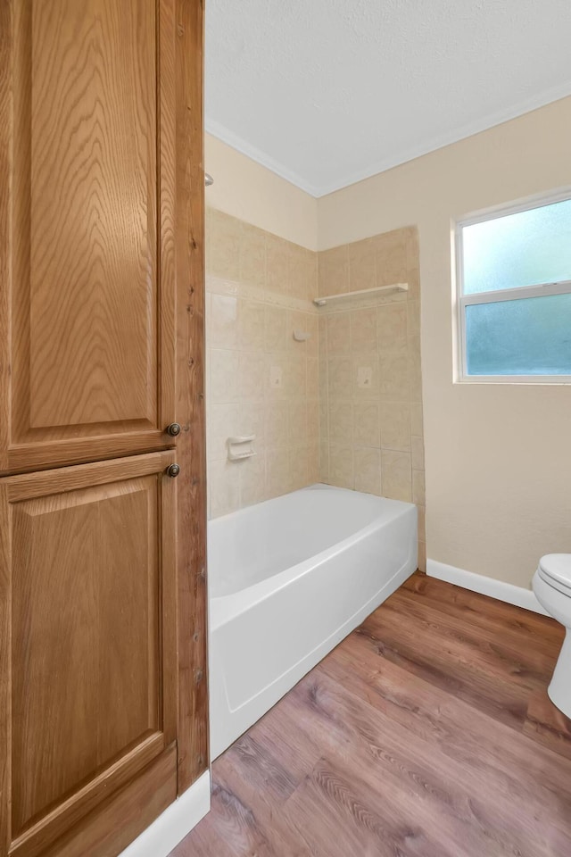 3205 Tennessee Ave, Fort Pierce, FL 34950 - full bathroom featuring baseboards, shower / tub combination, wood finished floors, and toilet
