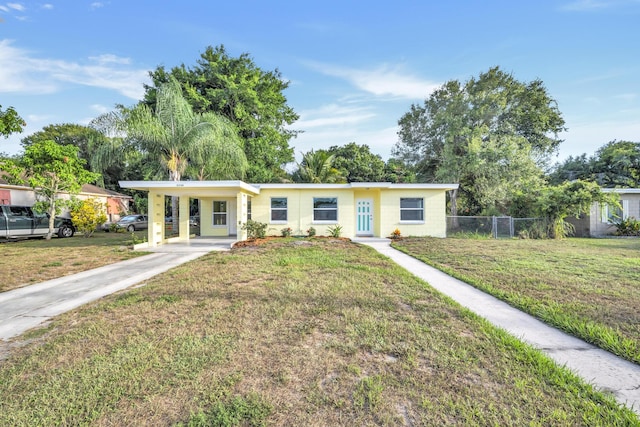 3205 Tennessee Ave, Fort Pierce, FL 34950 - single story home featuring fence, a carport, driveway, and a front lawn