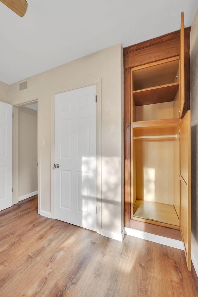 3205 Tennessee Ave, Fort Pierce, FL 34950 - unfurnished bedroom featuring baseboards, visible vents, wood finished floors, and a closet