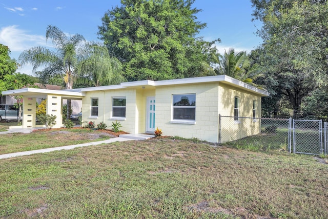 3205 Tennessee Ave, Fort Pierce, FL 34950 - view of front facade with a front yard, fence, and concrete block siding