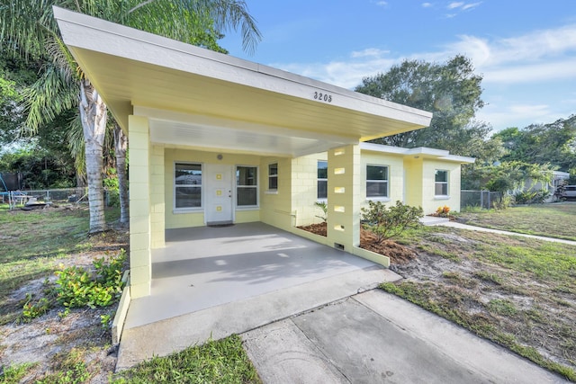 3205 Tennessee Ave, Fort Pierce, FL 34950 - exterior space featuring concrete driveway, concrete block siding, fence, and a carport