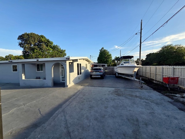 10090 W Fern St, Miami, FL 33157 - view of front of house with concrete driveway, fence, and stucco siding