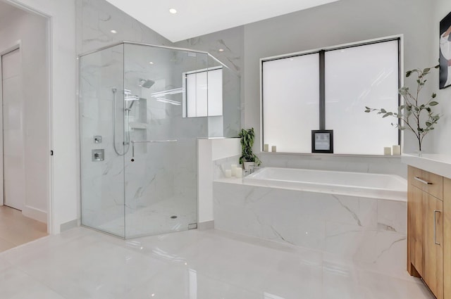 full bathroom featuring a marble finish shower and a bath