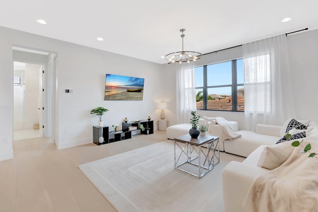 living room featuring recessed lighting, baseboards, and a chandelier