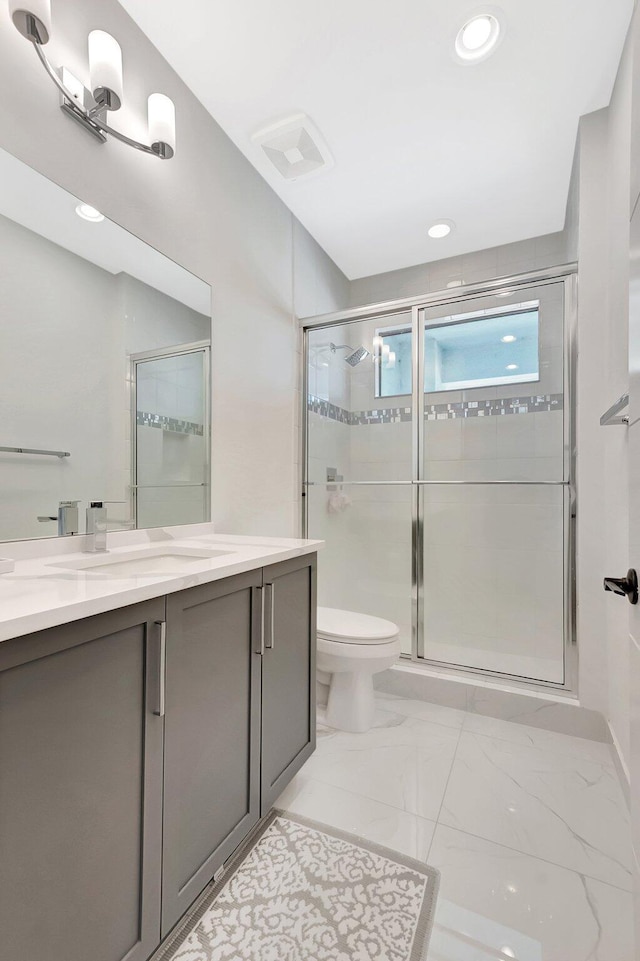 bathroom with vanity and a stall shower