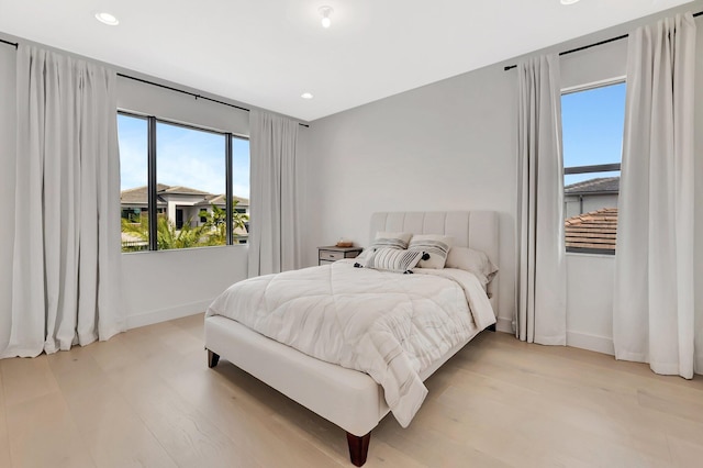 bedroom featuring recessed lighting, baseboards, and light wood-style flooring