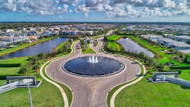 drone / aerial view with a water view and a residential view