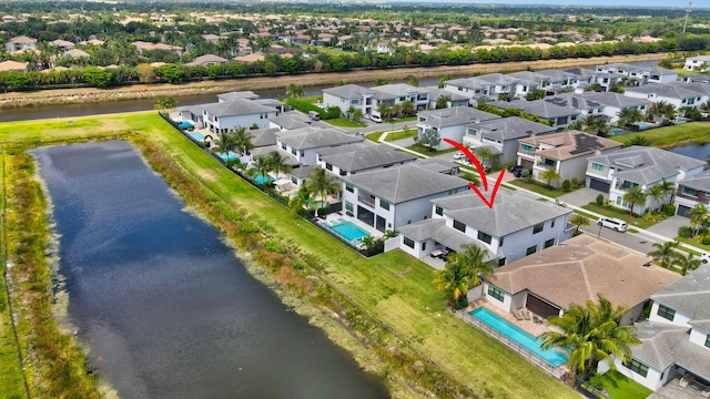 drone / aerial view with a residential view and a water view