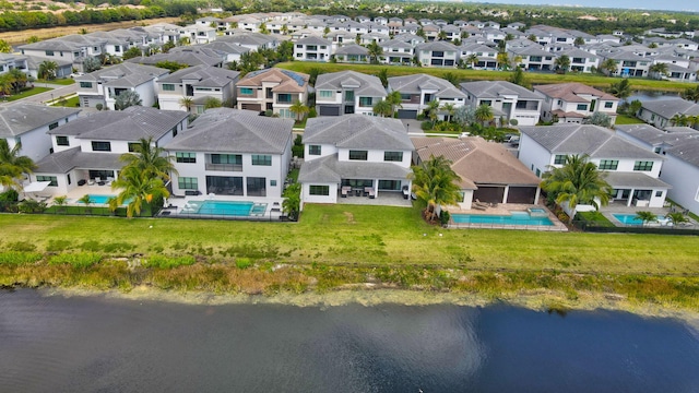 bird's eye view featuring a water view and a residential view