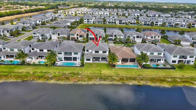 drone / aerial view featuring a residential view and a water view