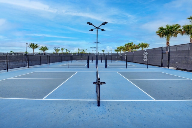view of tennis court featuring fence