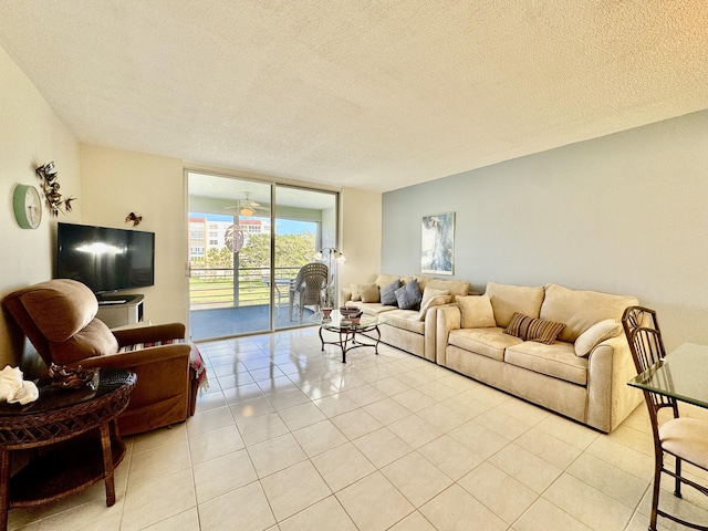 living area with expansive windows, a textured ceiling, and light tile patterned flooring