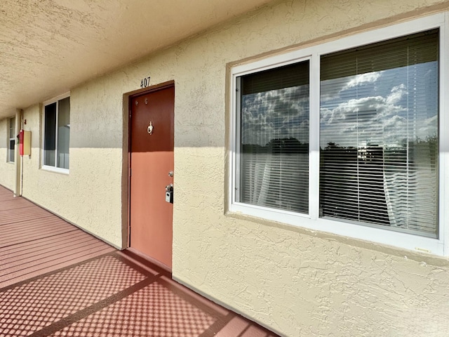 view of exterior entry with stucco siding