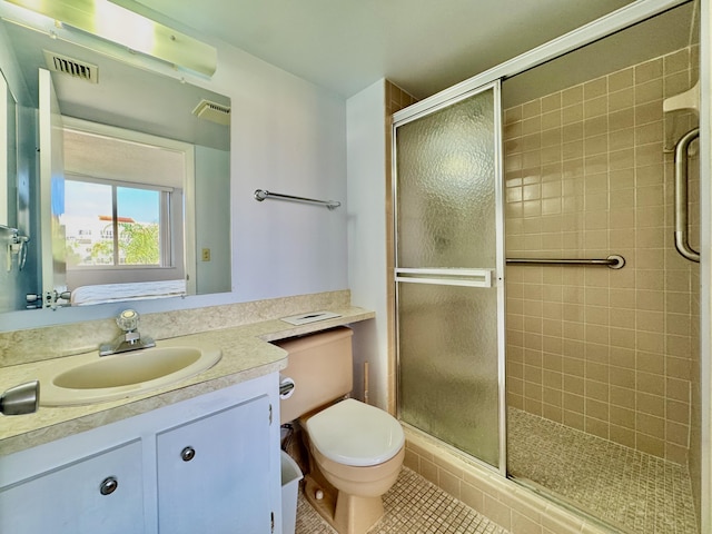 full bathroom with visible vents, vanity, toilet, tile patterned floors, and a shower stall
