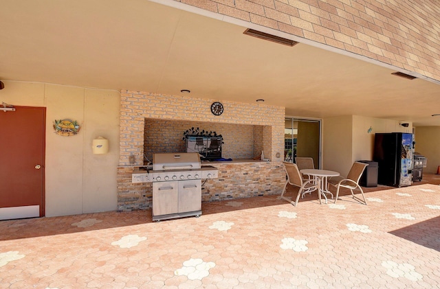 view of patio / terrace featuring visible vents, grilling area, and outdoor dining space