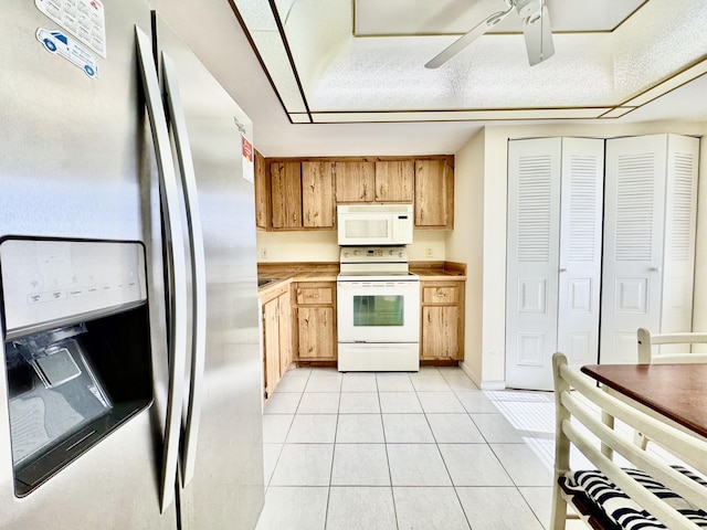 kitchen featuring a ceiling fan, light countertops, baseboards, white appliances, and light tile patterned flooring