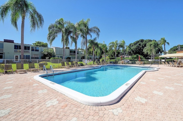 pool with fence and a patio