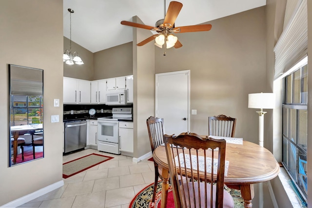 interior space with high vaulted ceiling, baseboards, ceiling fan with notable chandelier, white appliances, and white cabinetry