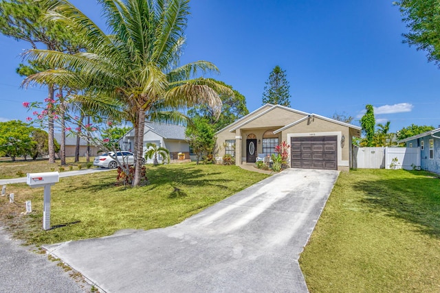 ranch-style home featuring a front yard, a garage, fence, concrete driveway, and stucco siding