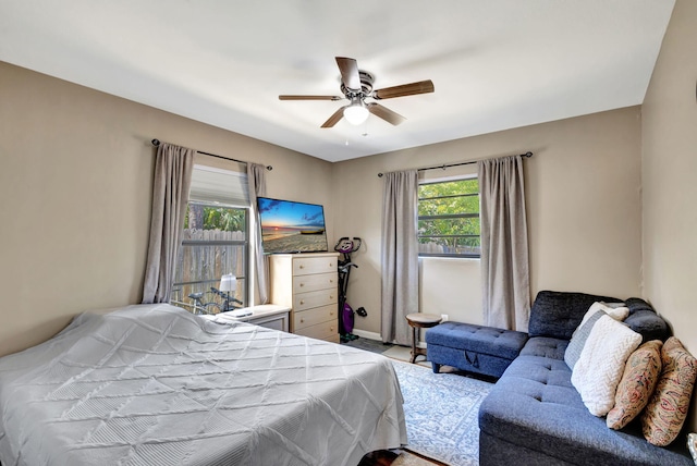 bedroom with a ceiling fan and baseboards