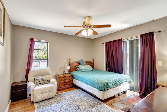 bedroom with baseboards, ceiling fan, and wood finished floors