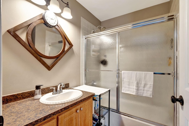bathroom with vanity and bath / shower combo with glass door